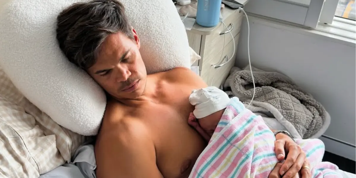 Jimmy Nicholson cradling his baby after Holly Nicholson gives birth