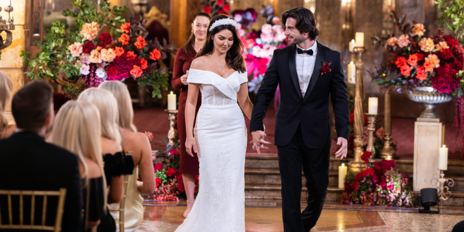 Eliot Donovan and Lauren Hall walk hand in hand after their wedding on MAFS 2025, surrounded by elegant floral décor and candlelight