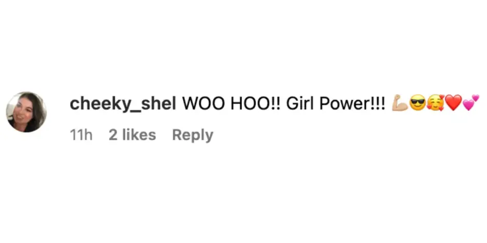 An Instagram comment by user "cheeky_shel" stating, "WOO HOO!! Girl Power!!!" followed by flexed bicep, sunglasses face, hugging face, red heart, and pink heart emojis.