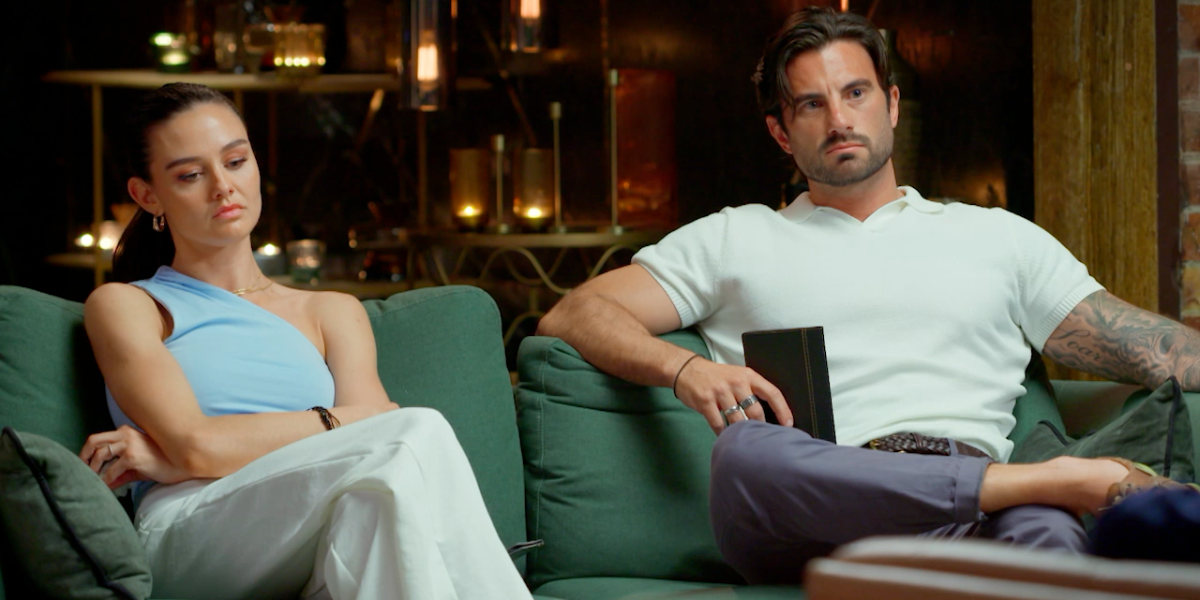 Veronica and Eliot from MAFS 2025 sit tensely on a couch, looking serious and distant